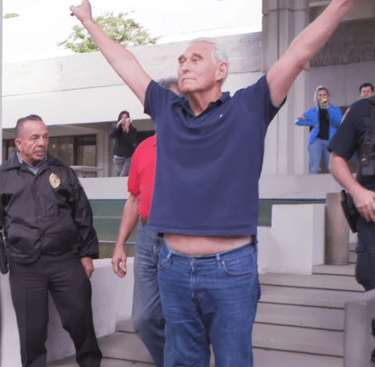 photo of Roger Stone flashing his Nixon V-sign after his indictment.