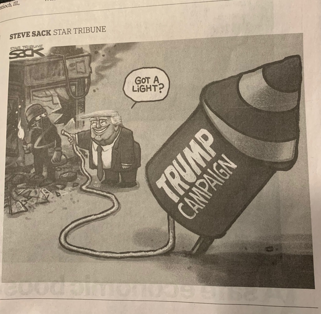 Steve Sack cartoon showing a person a man in black standing in the rubble left from a riot, holding a torch, and broadly grinning Donald Trump offering the rioter the fuse that that will ignite the fuel for his "Trump Campaign" rocket.
