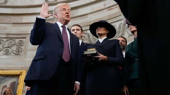 Donald Trump oath-taking with one hand.